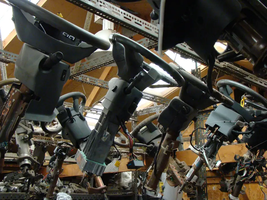 Used steering columns hung from the warehouse rafters at A & D Truck & Auto Parts, each one tagged