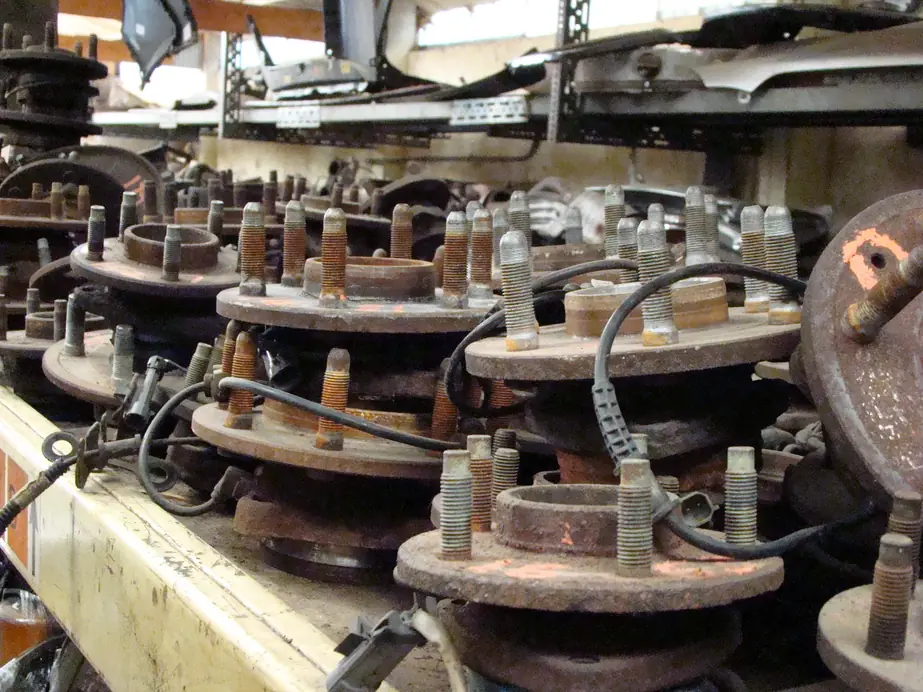 Used wheel hubs and brake rotors on the shelving at A & D Truck & Auto Parts
